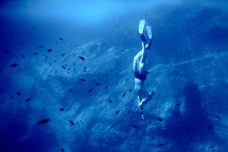 Freediver swimming in the ocean